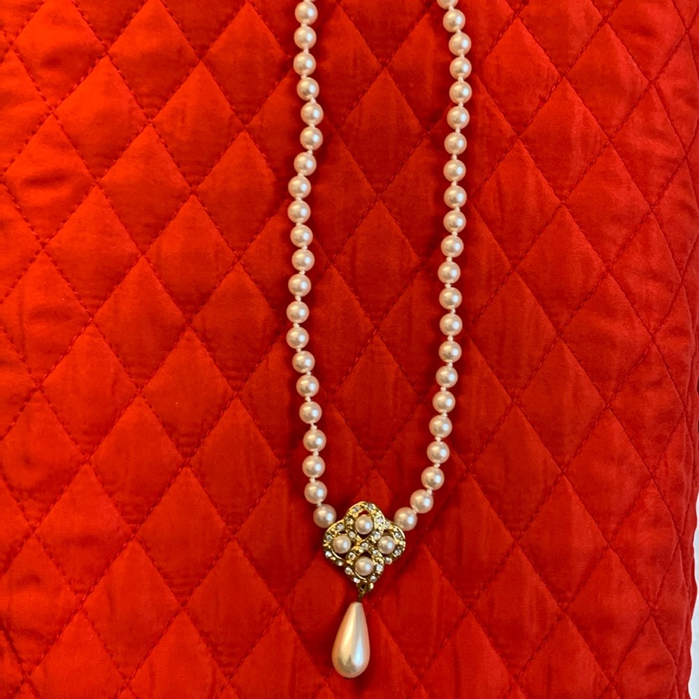 19” pearl-like necklace with pearl bead, rhinestone, & goldtone  cluster.